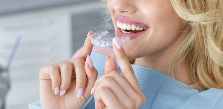 woman holding invisalign